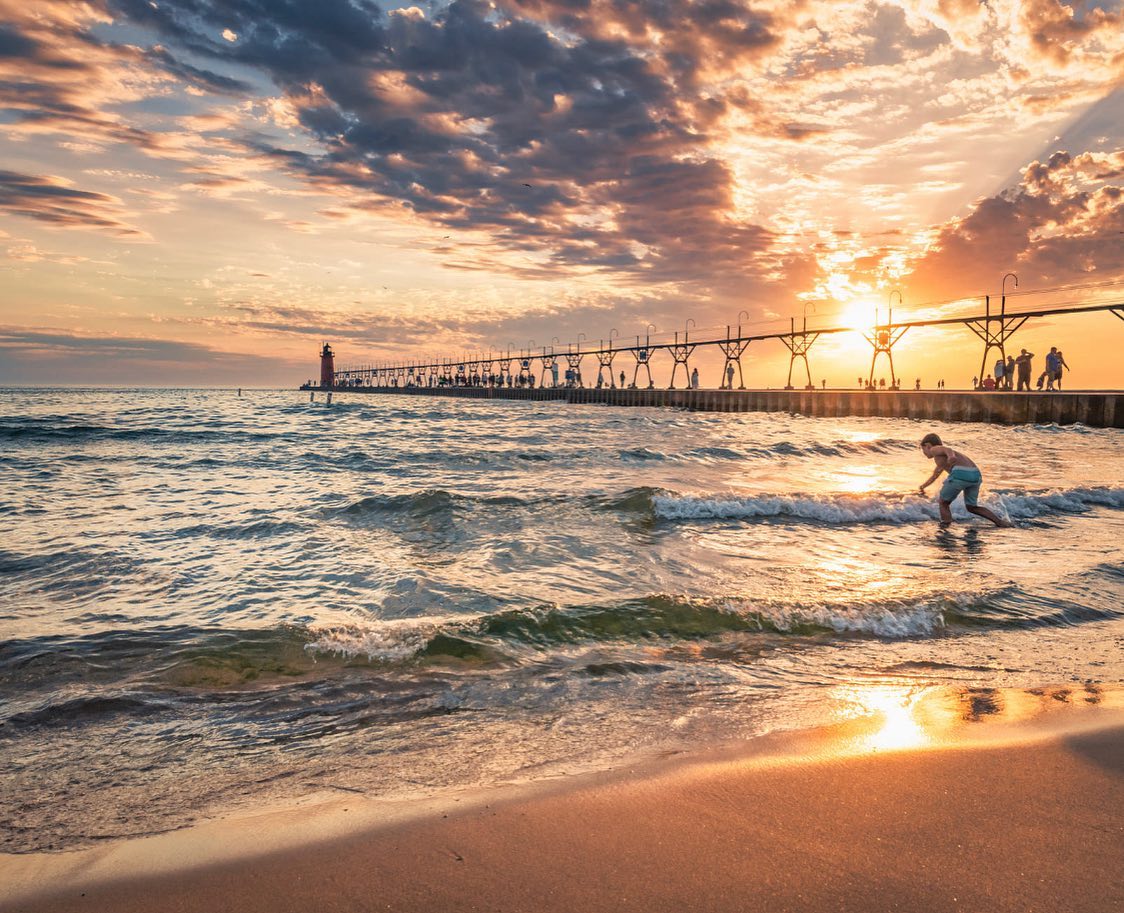 Lake Michigan in South Haven Child playing in water by the lighthouse in South Haven