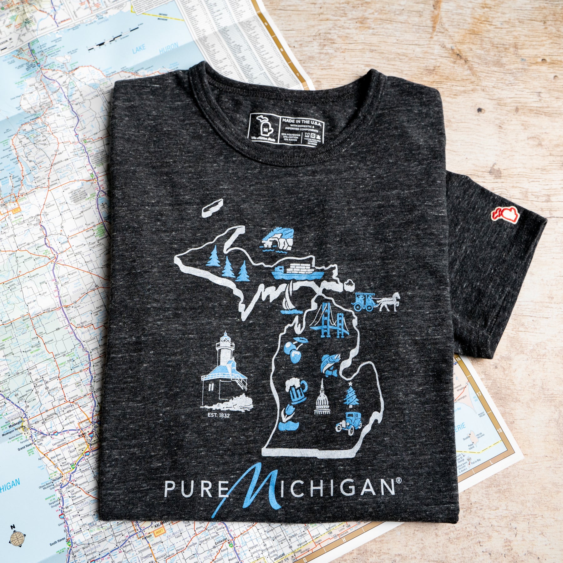 Pure Michigan - Michigan Map shirt Graphic T-shirt with the Pure Michigan logo and a state outline decorated with cultural icons