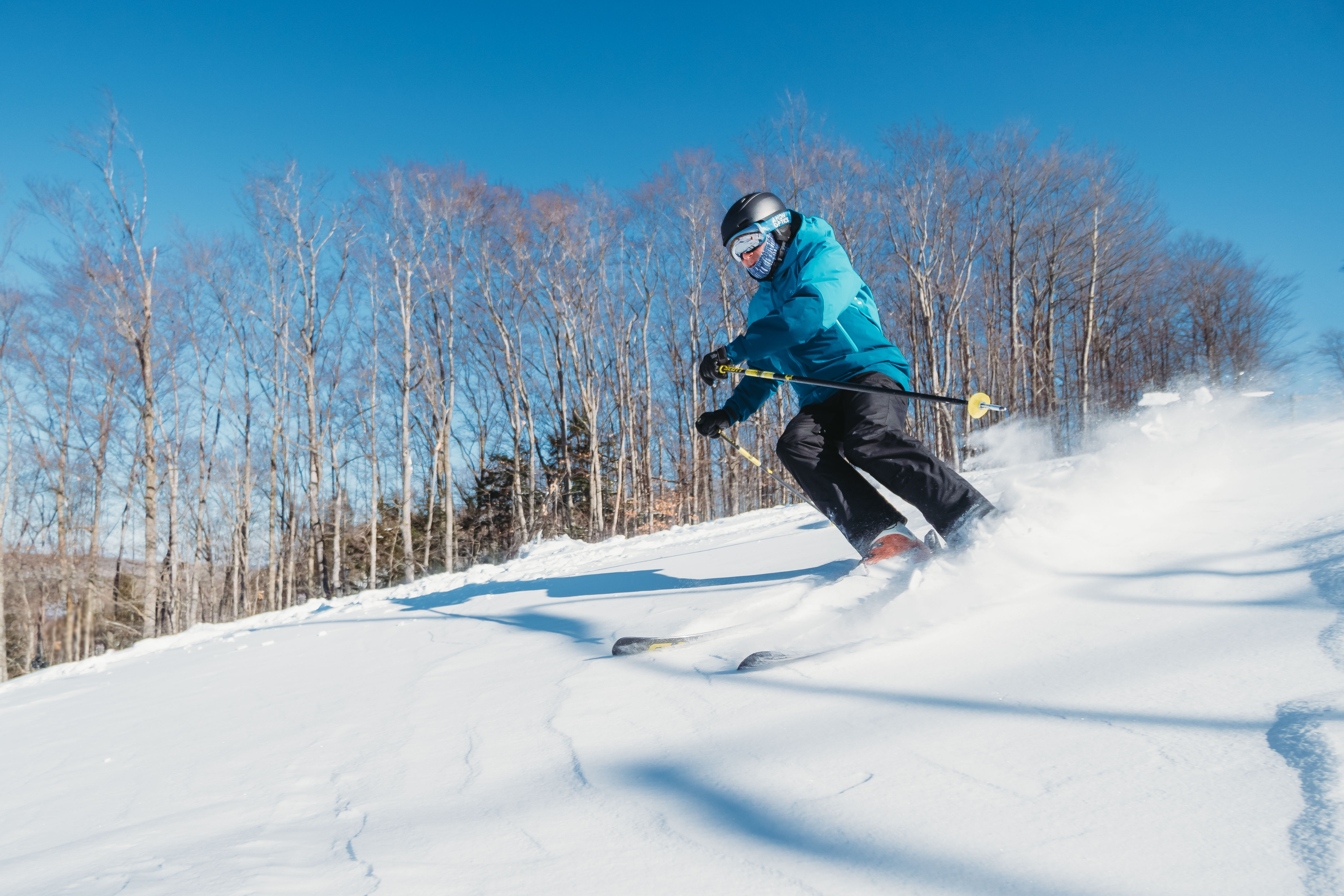 A man skiing down a hill at Treetops Resort