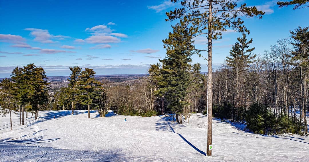 Pin Mountain Ski Resort A ski run surrounded by pine trees at Pine Mountain Ski Resort