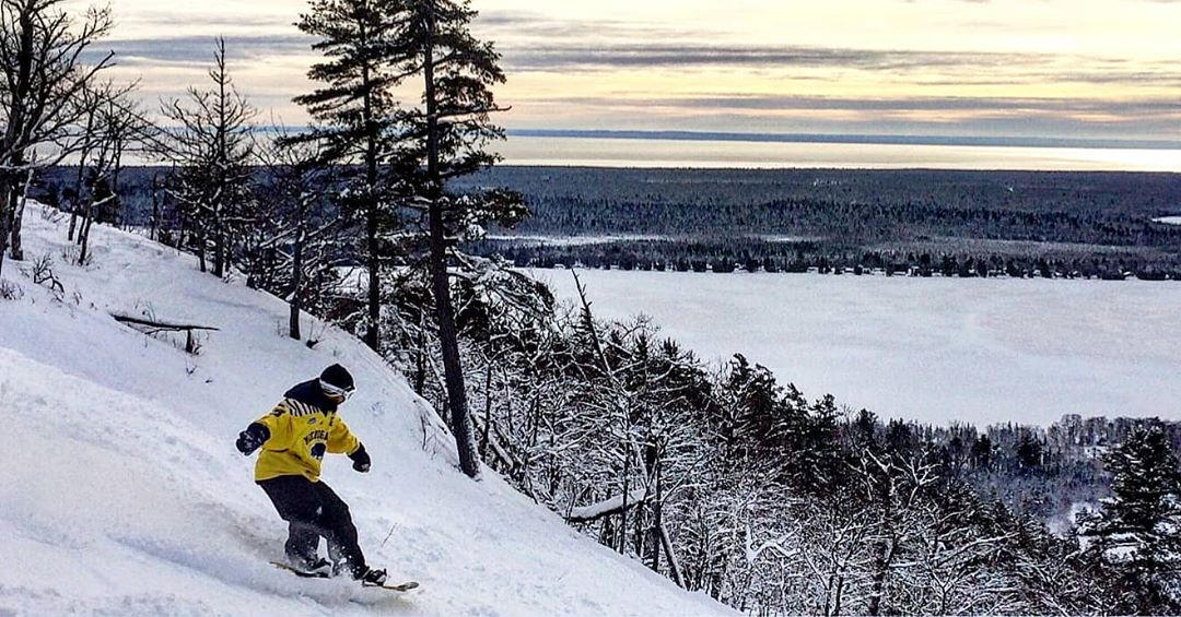 Snowboarding on Mount Bohemia A man snowboarding down Mount Bohemia