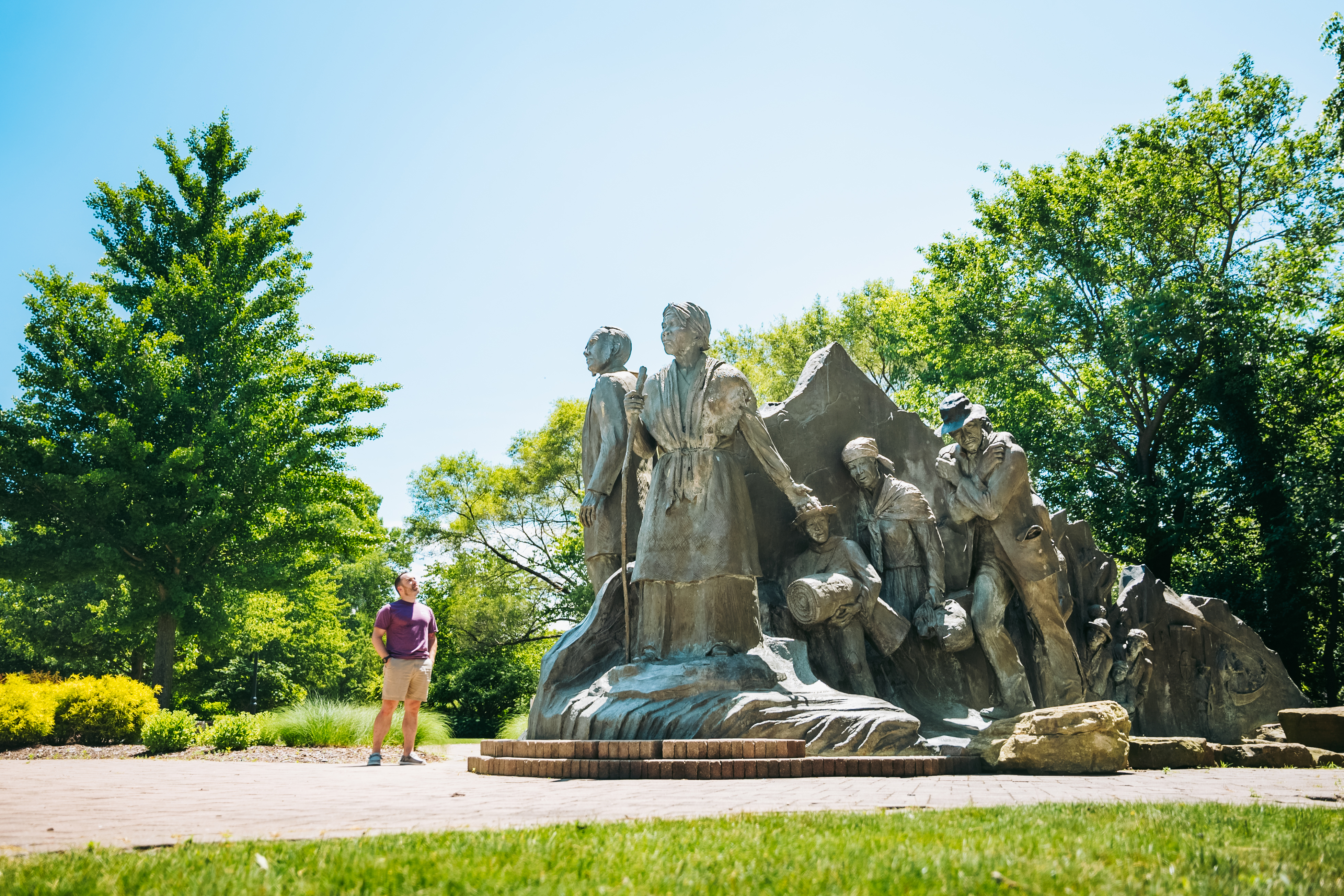 Underground Railroad Monument A man looking at a statue commemorating the Underground Railroad