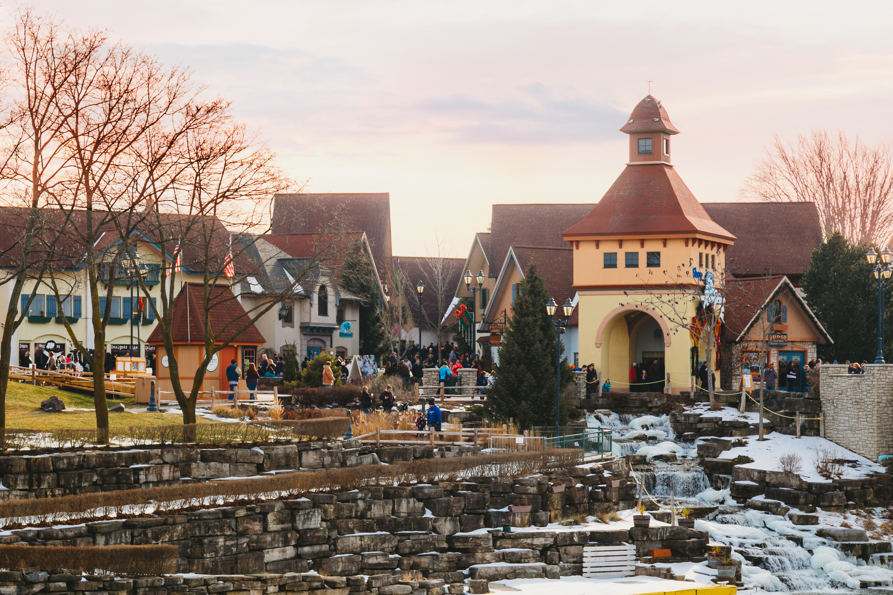 Local shops by an artificial waterfall into a river. 