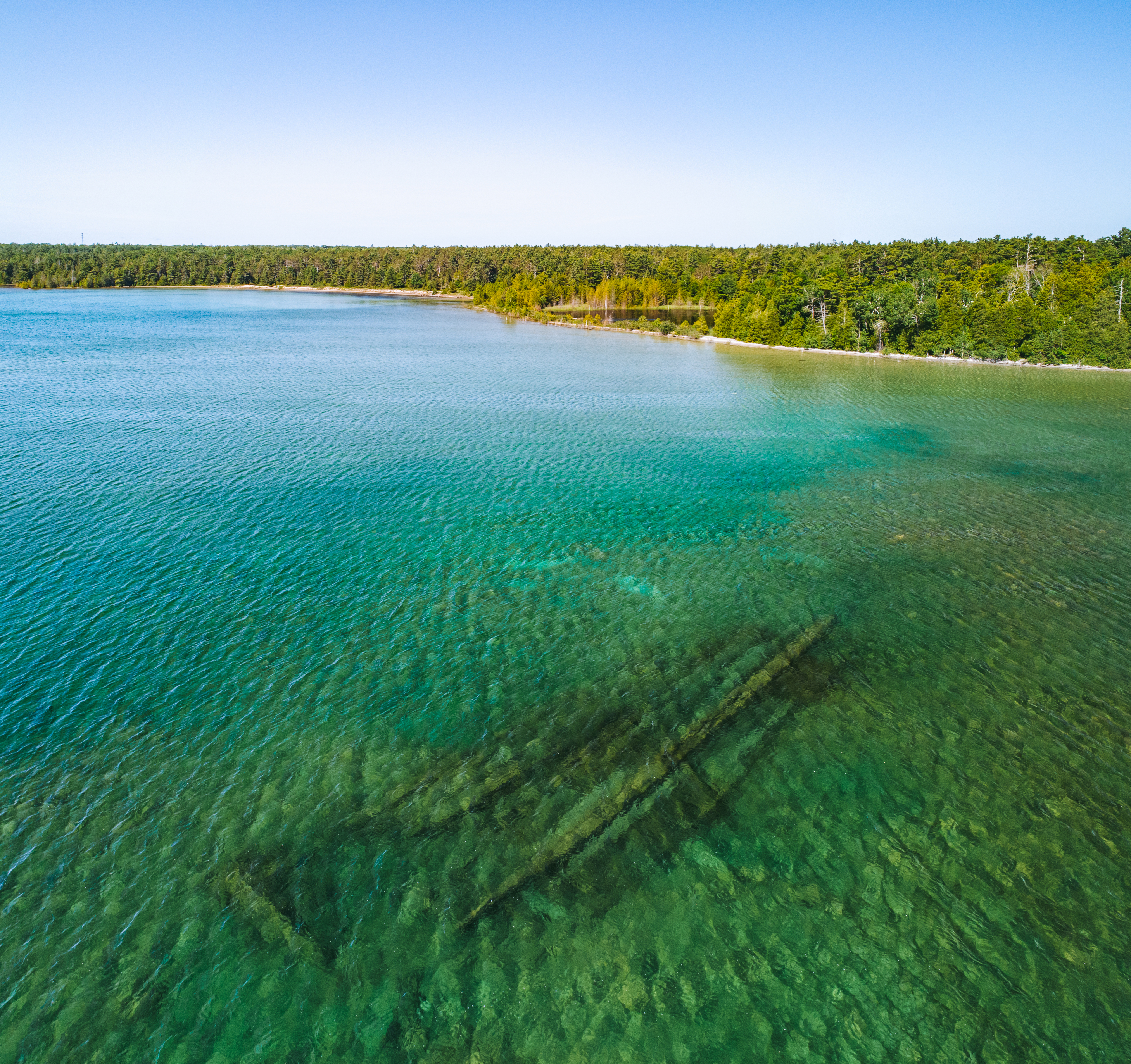 Thunder Bay National Marine Sanctuary A shipwreck under water in Lake Huron near the shore.
