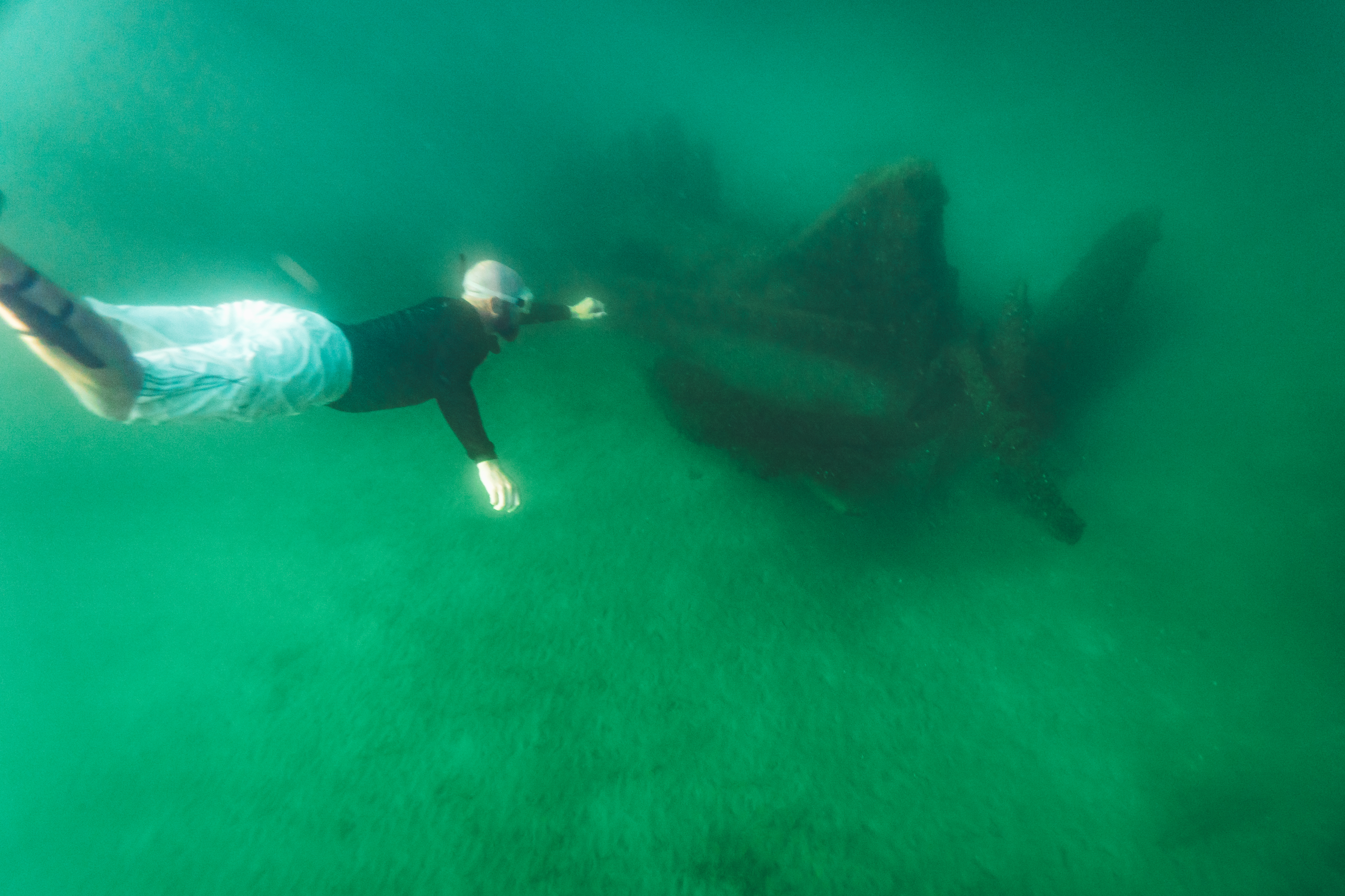 Snorkeling over shipwrecks in Lake Huron A man snorkeling above a shipwreck in Lake Huron