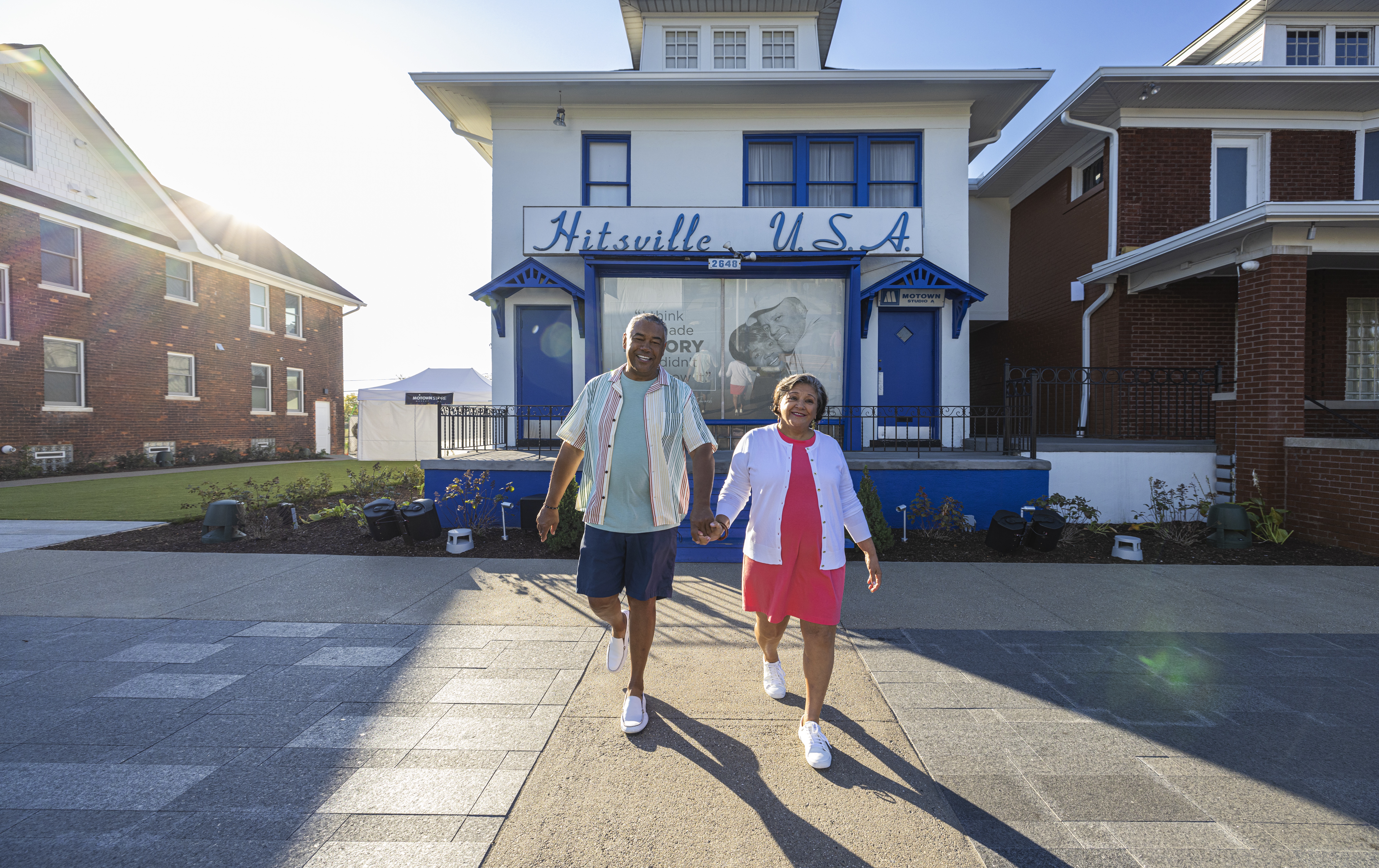 A man and woman holding hands outside of the Motown Museum