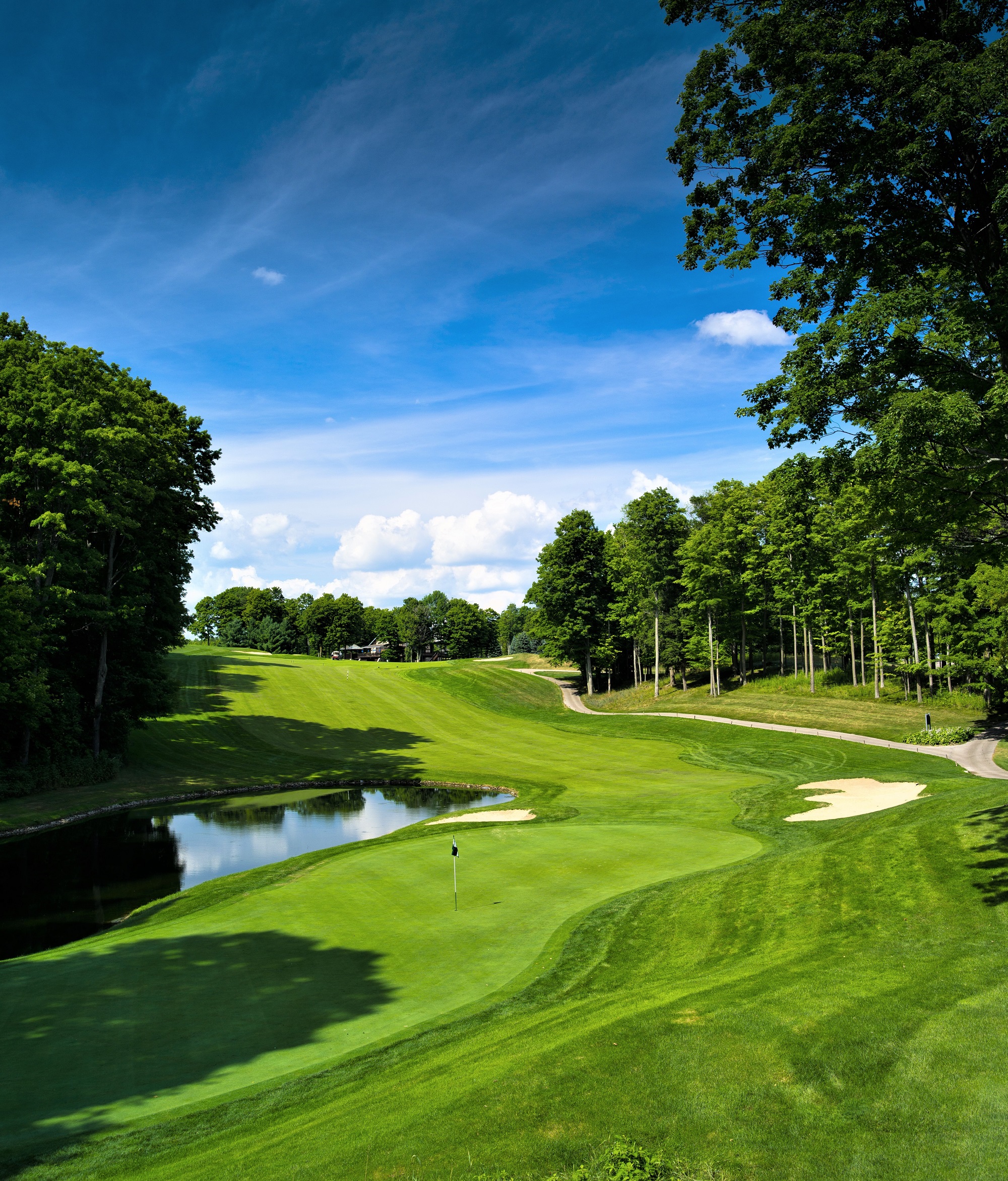 Treetops Resort A golf course with a water feature surrounded by trees.