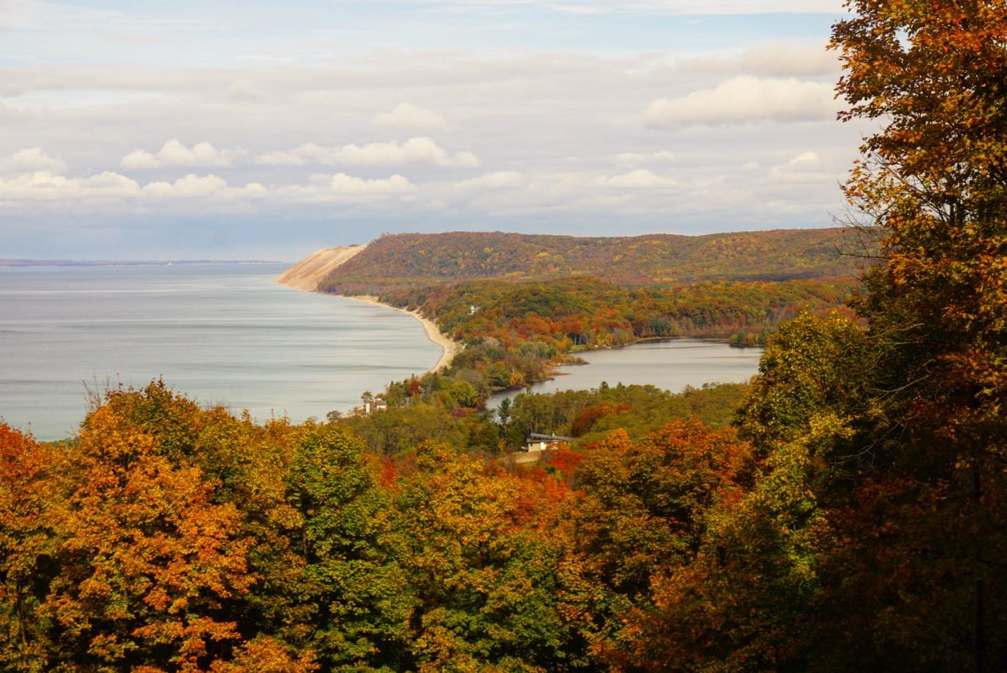 Sand dune bluffs covered with fall trees on the shore of Lake Michigan