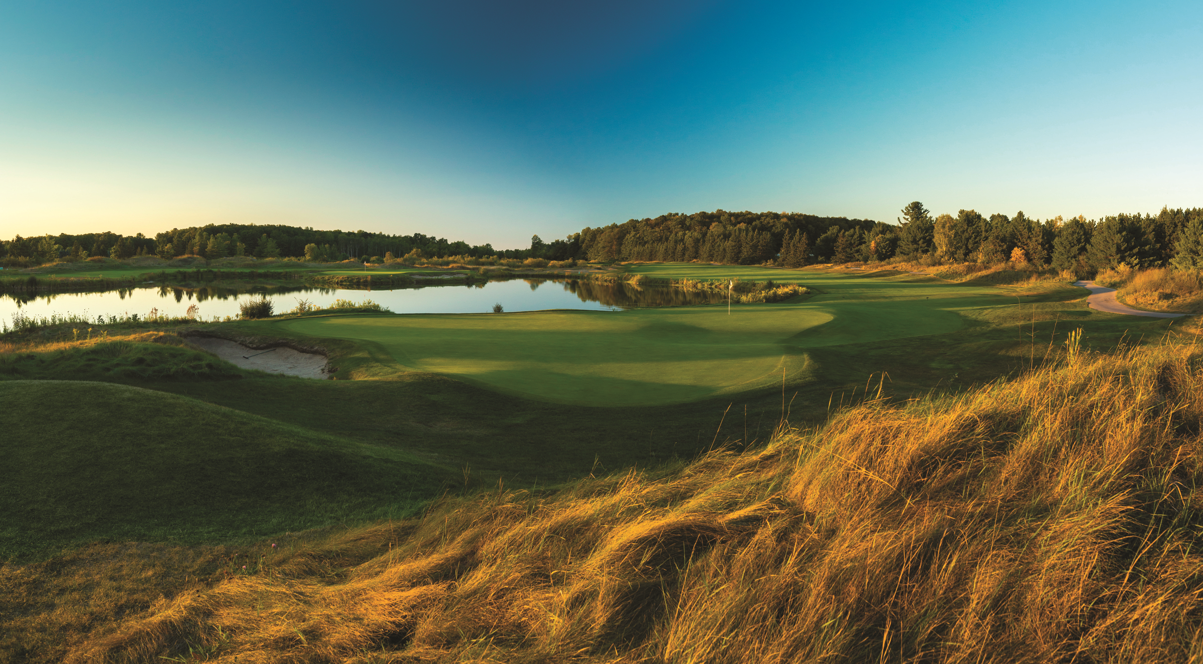 The Bear Golf Course at Grand Traverse Resort and Spa A golf course with a pond in the middle