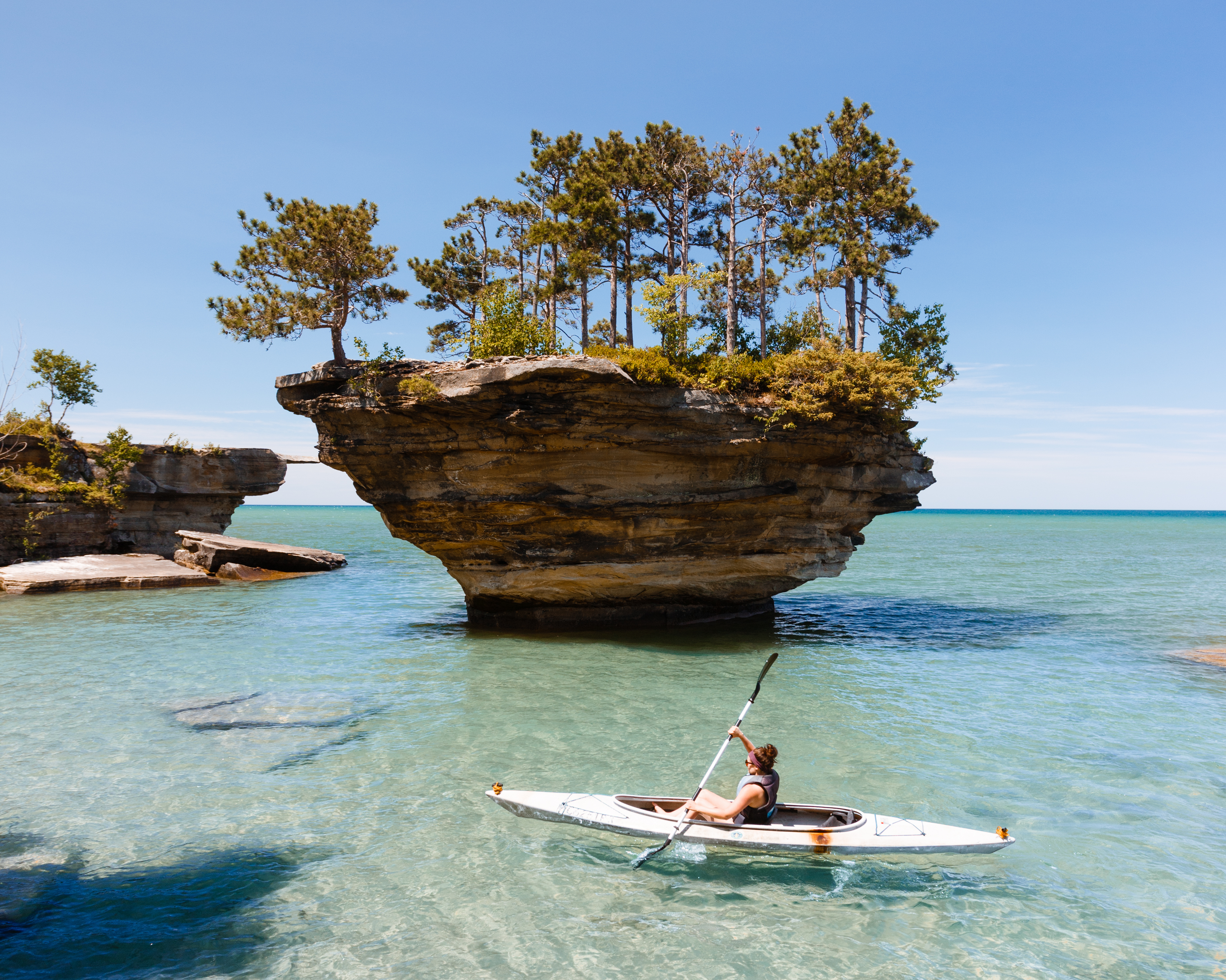 Turnip Rock A woman kayaking around a rock formation in Lake Huron