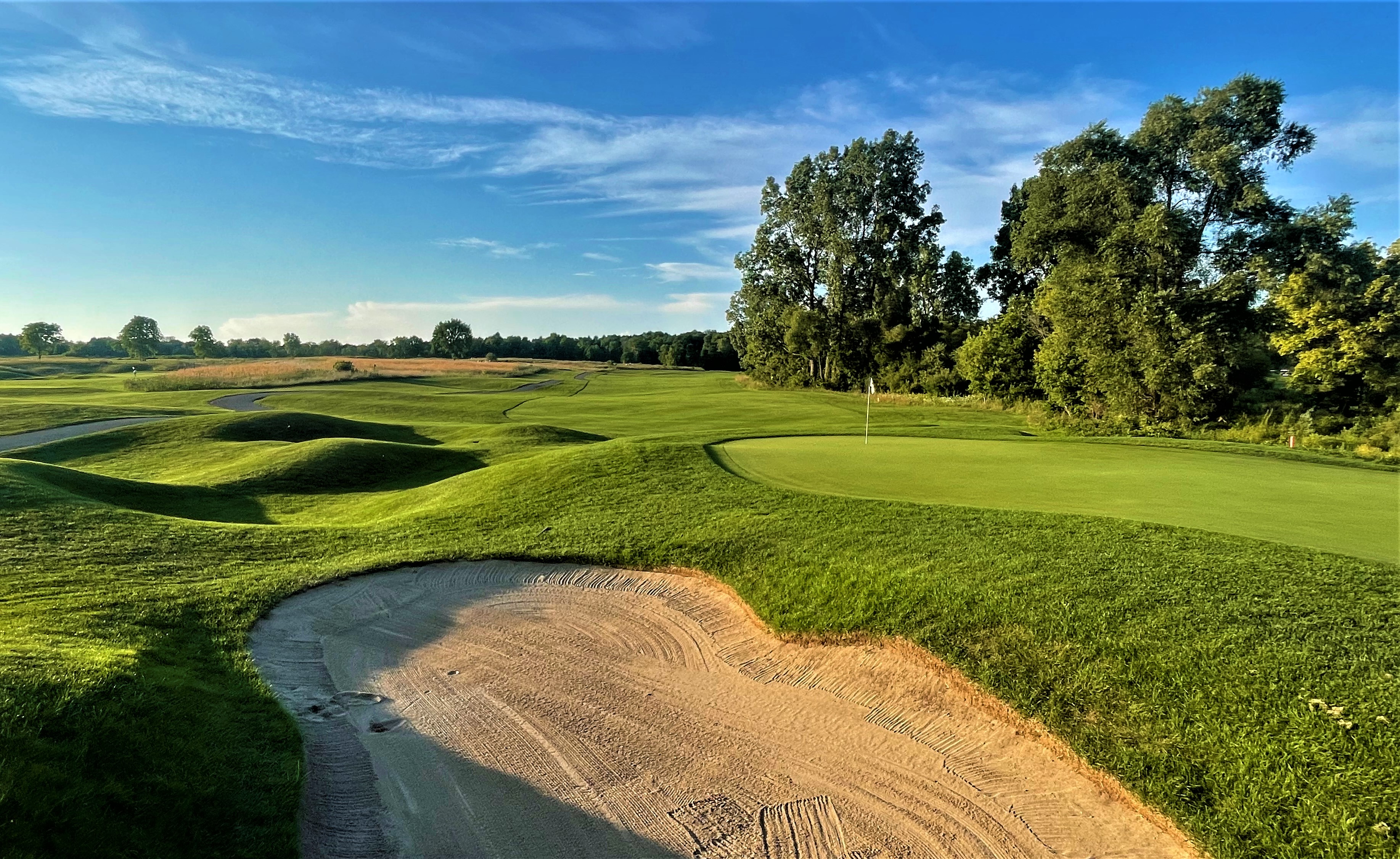 A golf course with a sand hazard. 