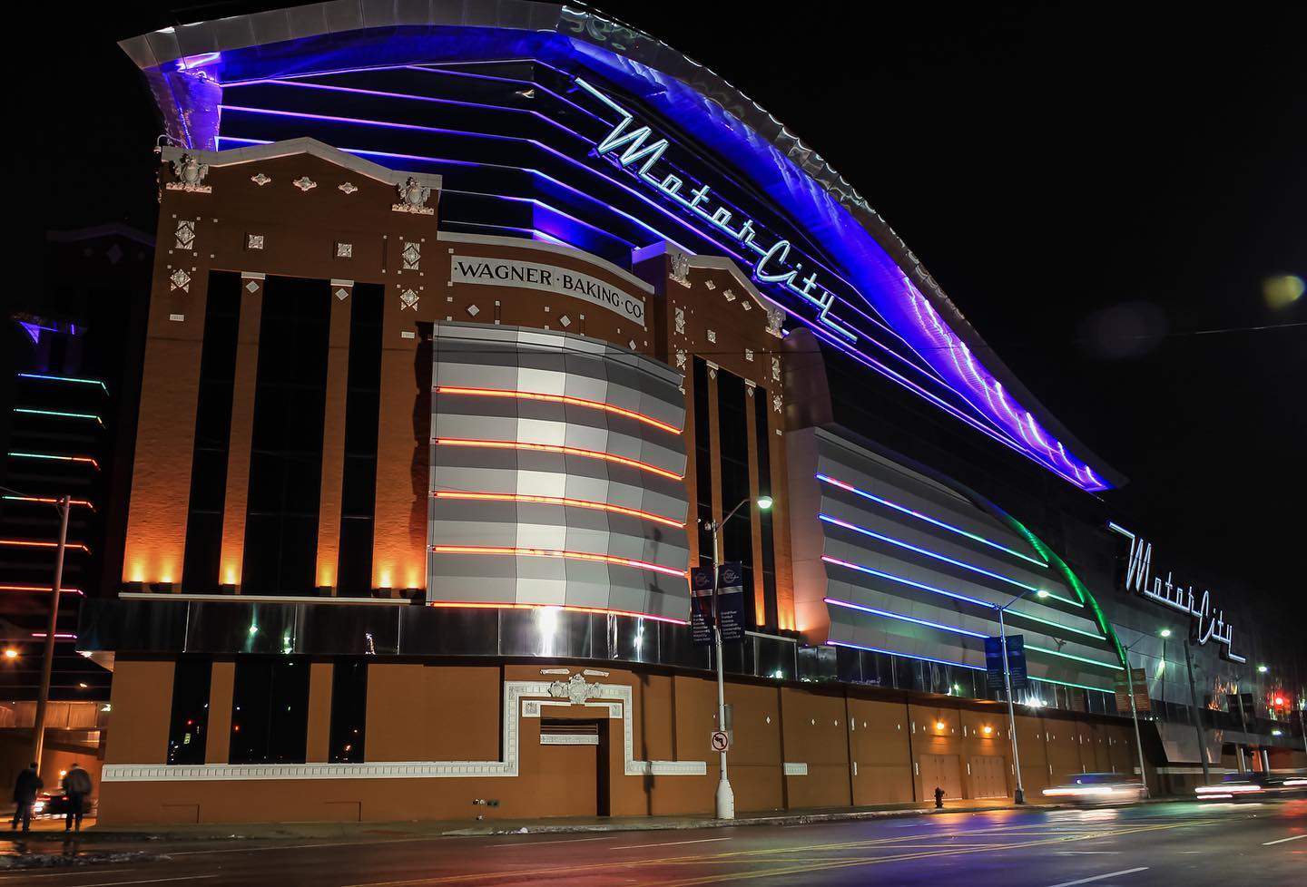 exterior of motorcity casino at night lit up
