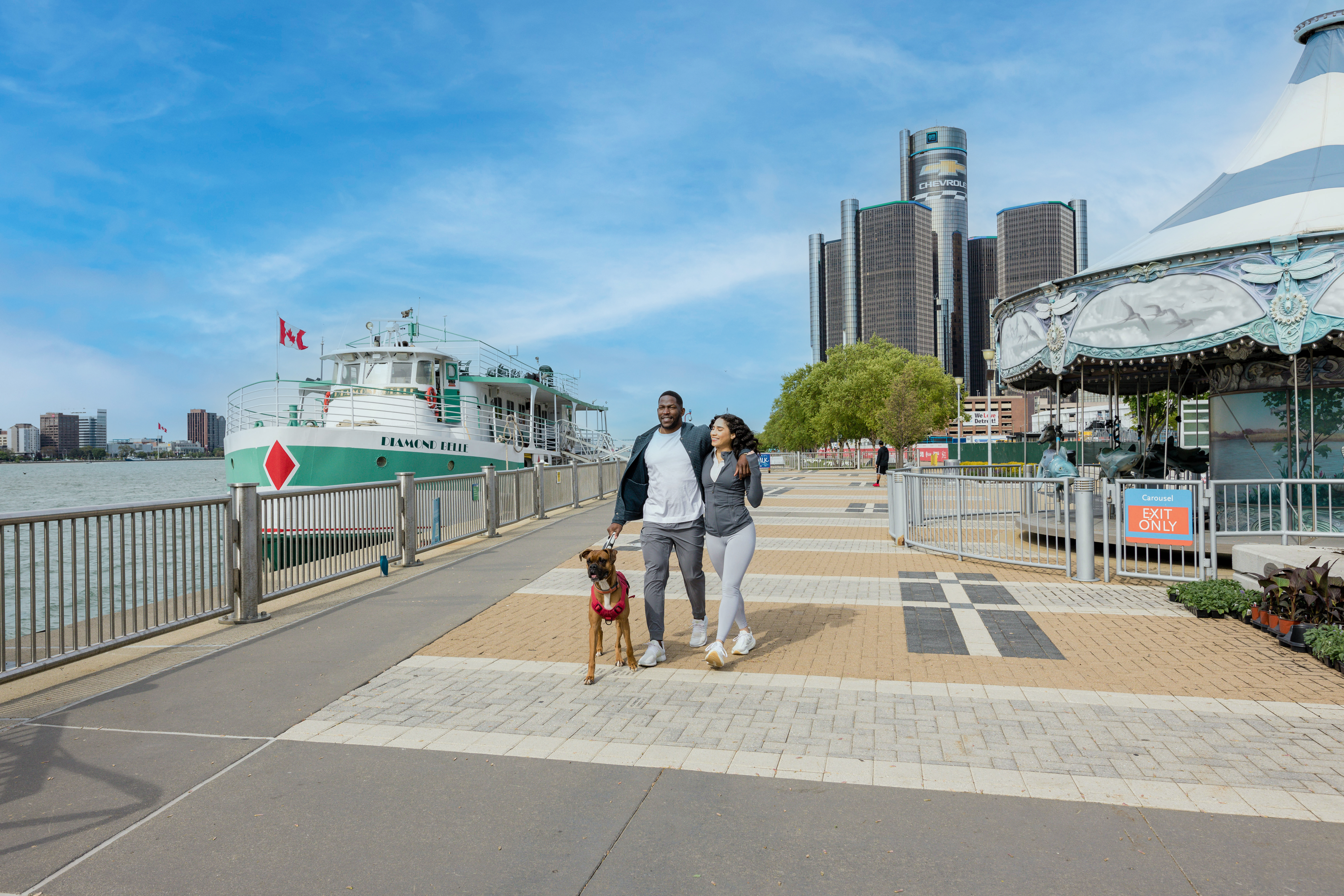 Detroit RiverWalk A man and woman walking their dog on the Detroit Riverwalk.