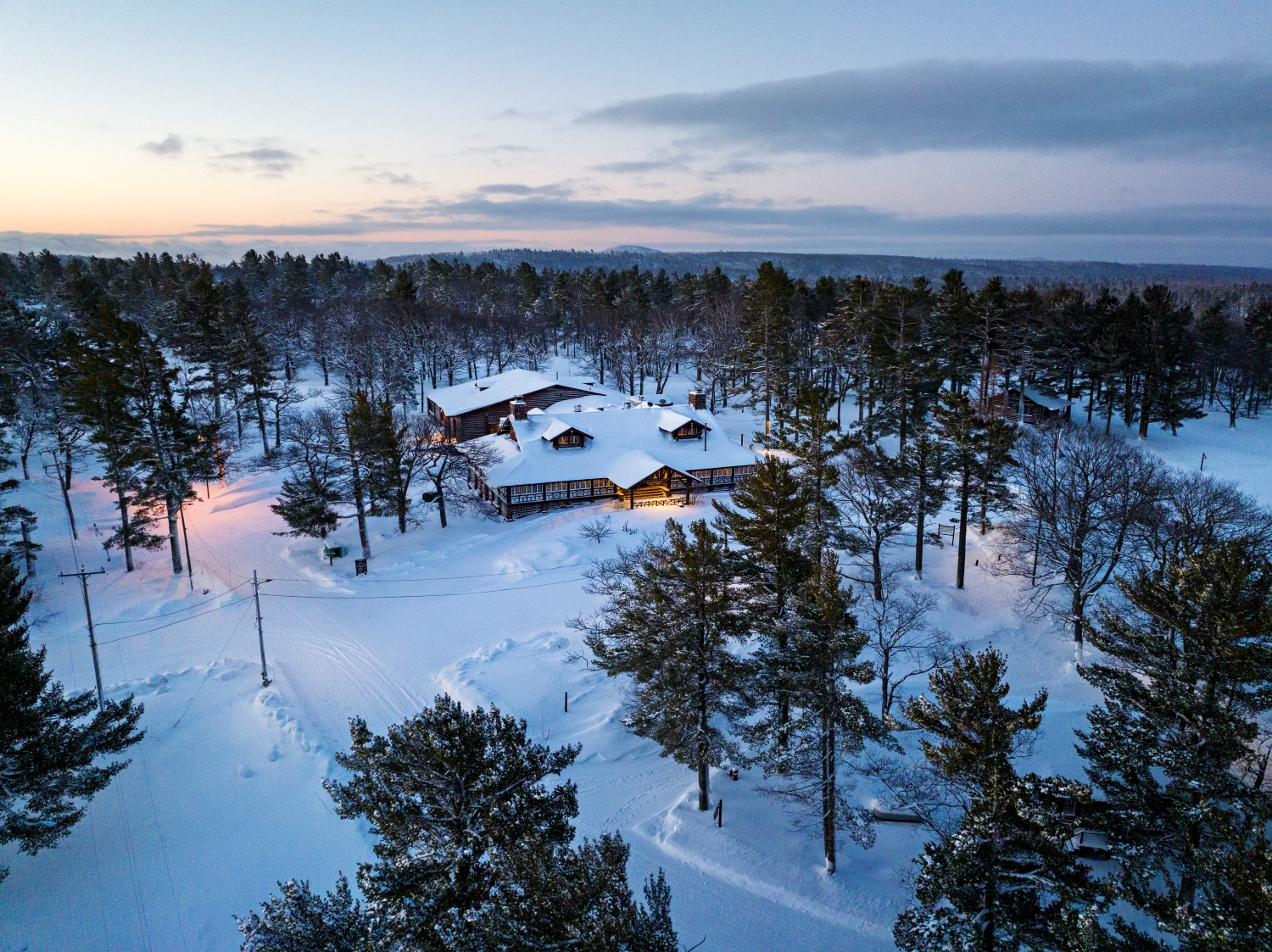 Keweenaw Mountain Lodge A log cabin style lodge in a snowy forest.