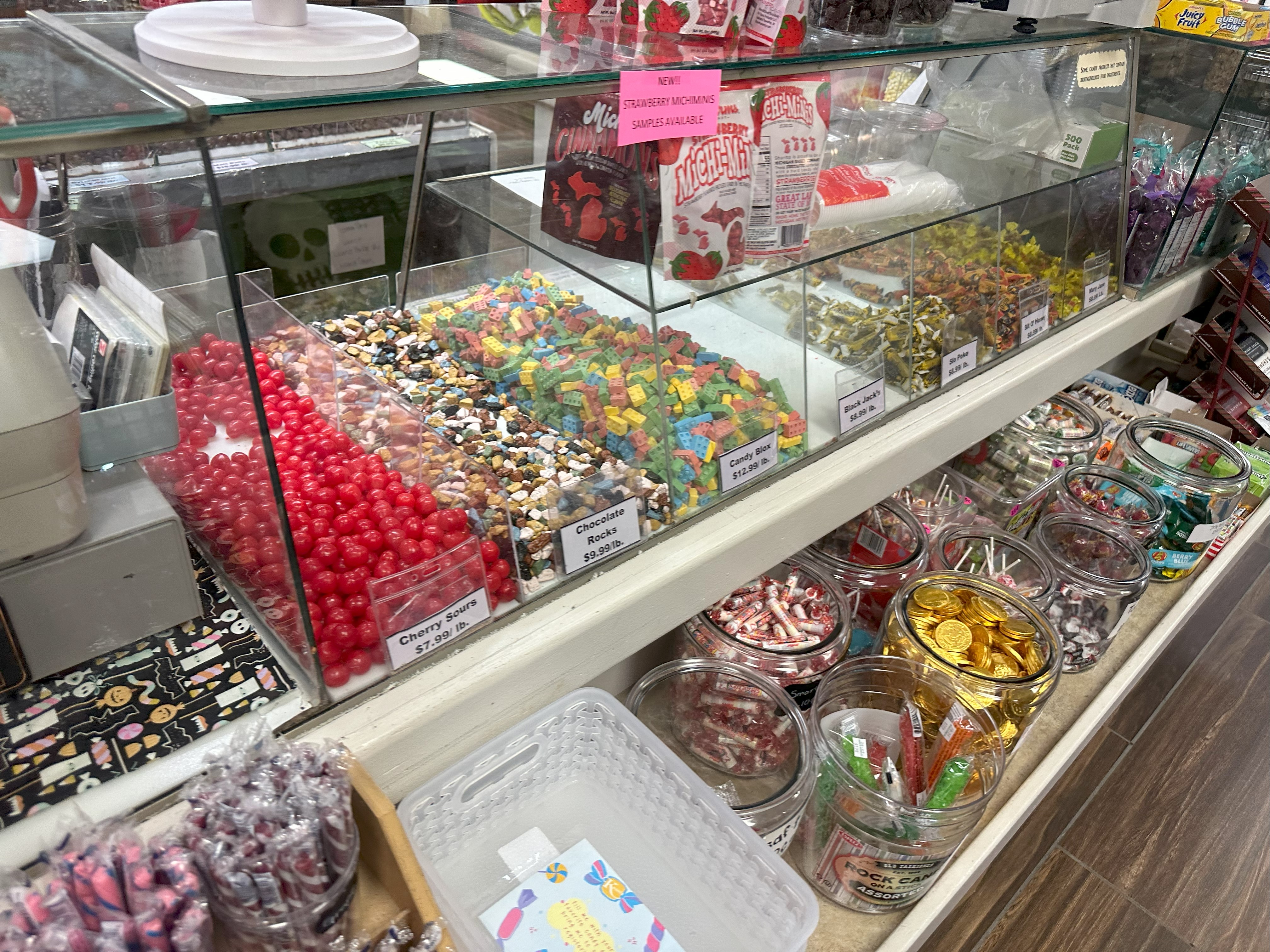 An assortment of hard candies and chocolates at a candy counter. 