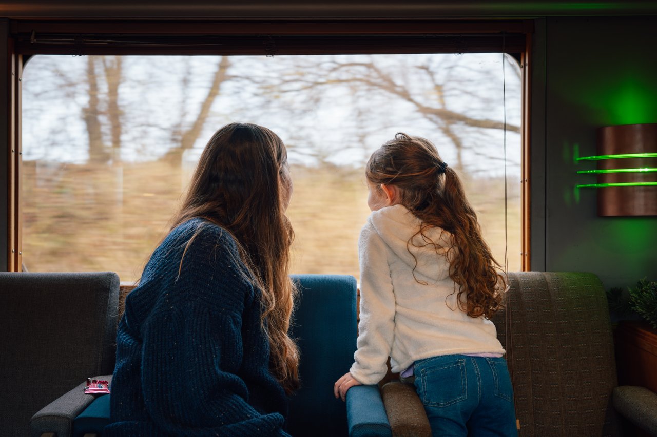 North Pole Express A woman and girl looking out the window of a train.