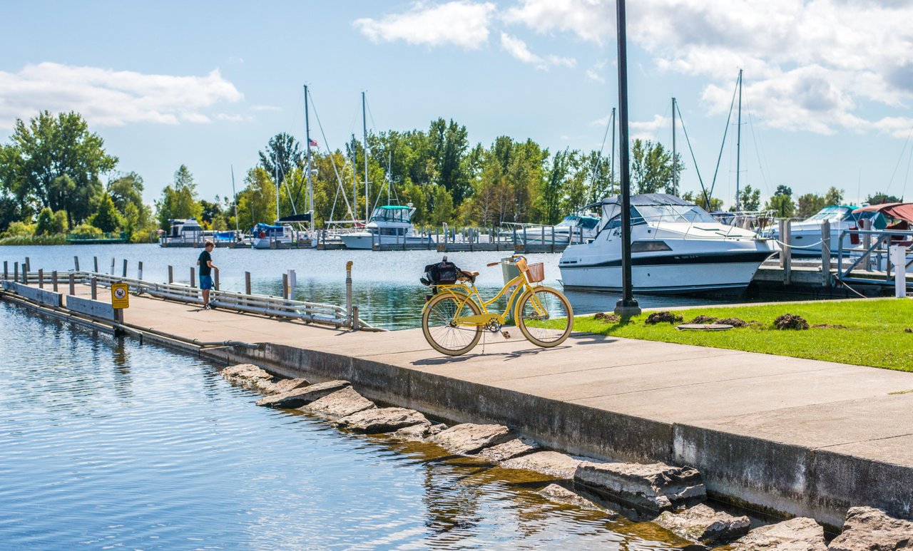Escanaba A boy fishing on a small pier by docked boats in Escanaba.