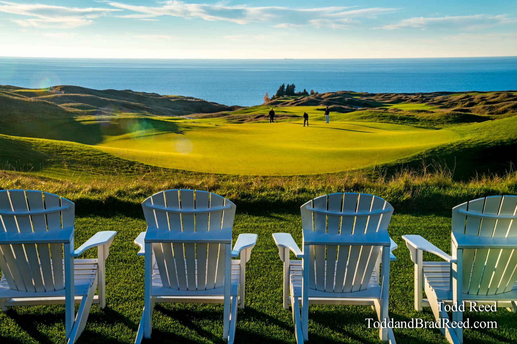 Lounge chairs overlooking a golf course along the coast of Lake Michigan.