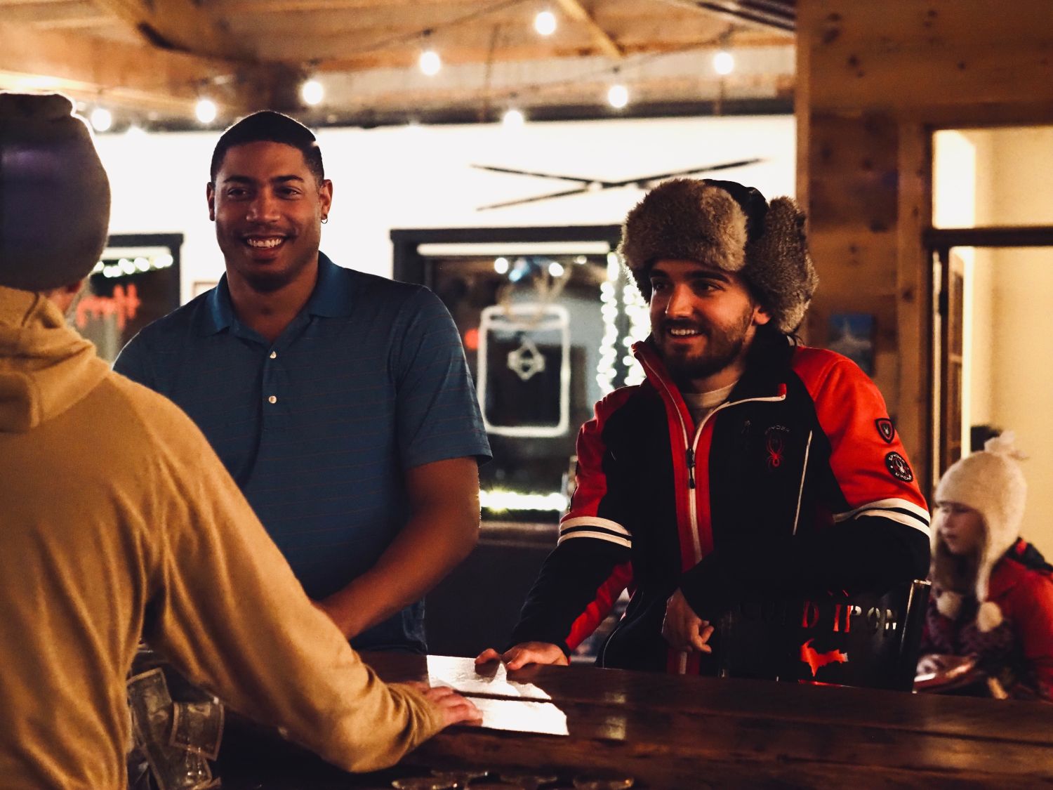 Two men talking at at the bar at Cold Iron Brewing.