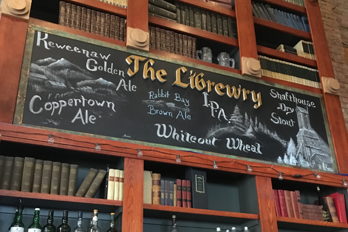 A chalkboard sign listing craft beer on tap.