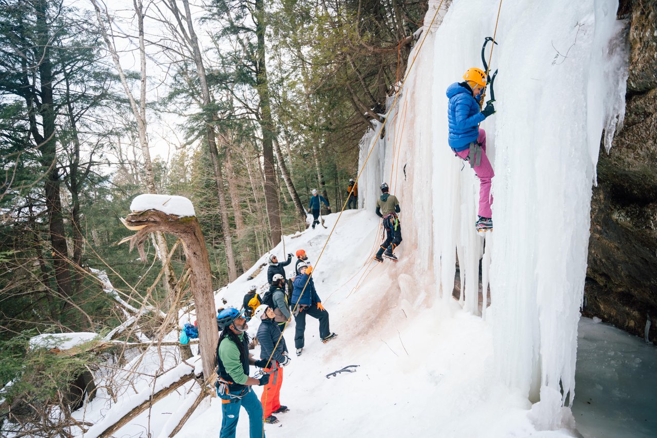 Michigan Ice Fest Instructors teaching participants how to ice climb at an ice curtain.