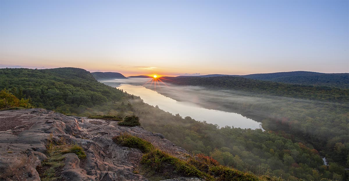 A view of the sun rising over Lake of the Clouds in Michigan's Porcupine Mountains