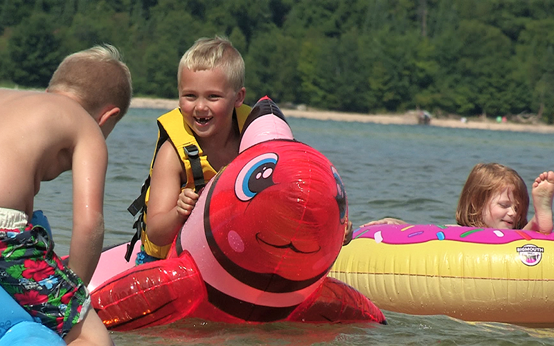 kids i the water on inner tubes and animal rafts