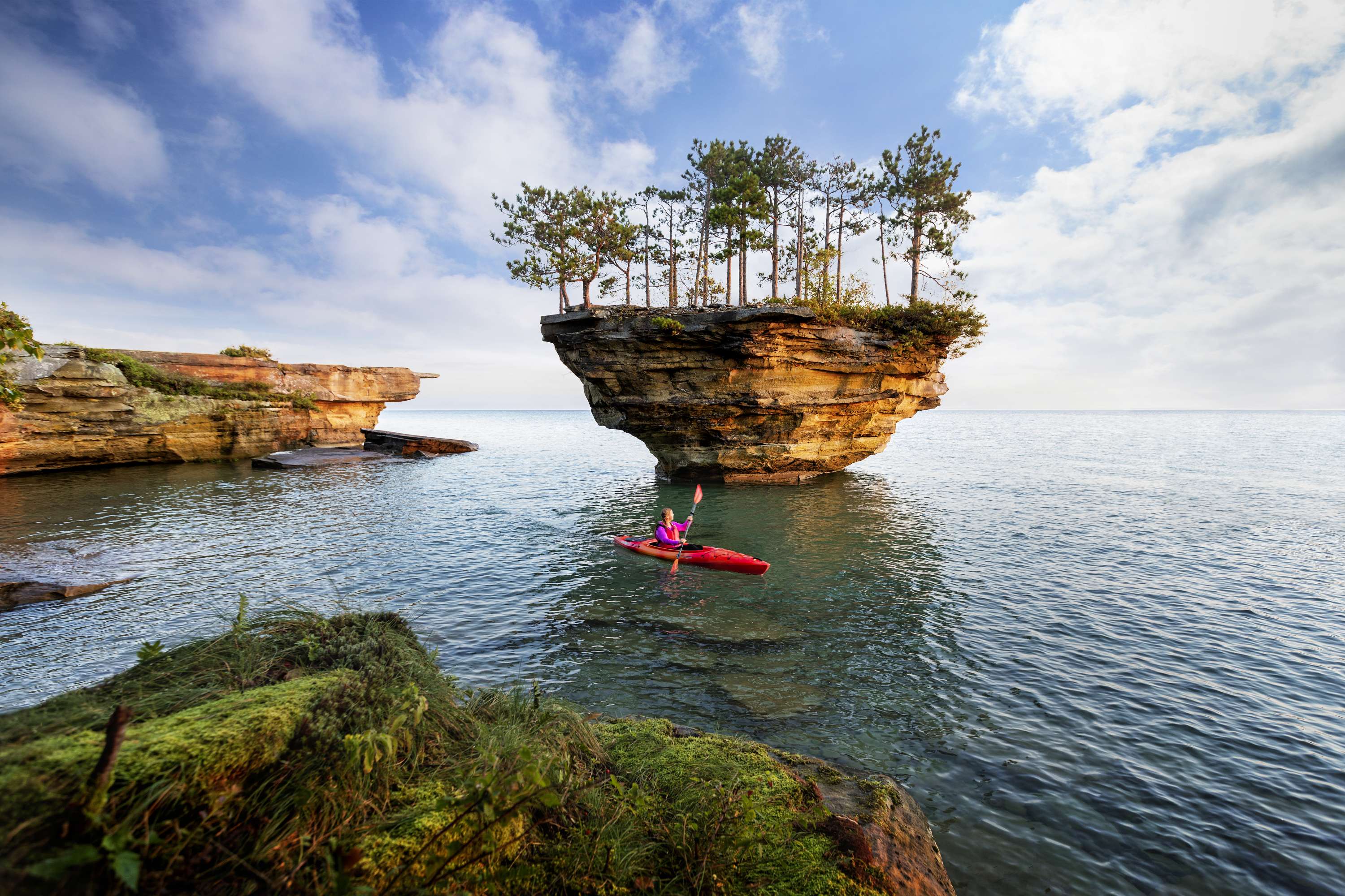 Turnip Rock A woman kayaking around a rock formation in Lake Huron