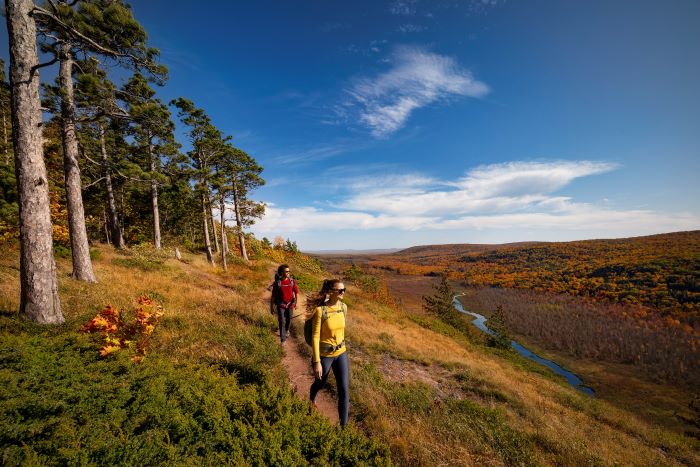 Couple hiking in a valley during fall