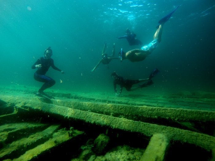 Scuba drivers exploring an Alpena Shipwreck in Lake Huron.