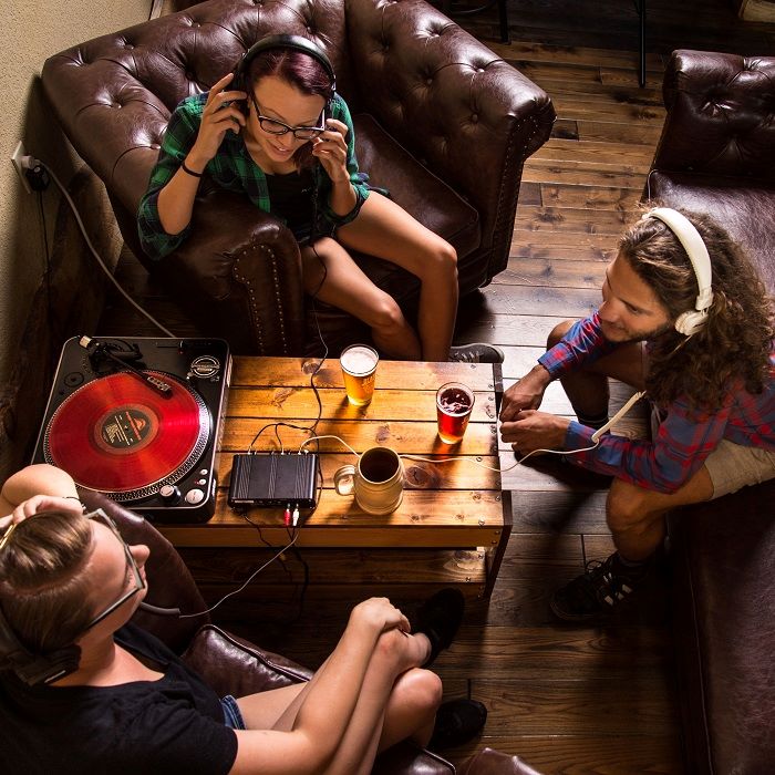 People listening to music from a record player at Beards Brewery