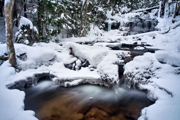Wagner falls surrounded by snowy forest