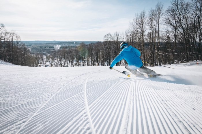 Skiier on fresh-groomed snow at Schuss Mountain