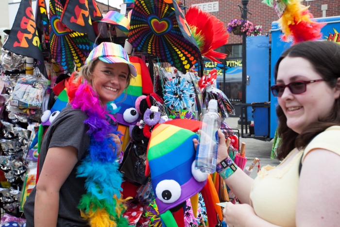Women buying festival gear at Ferndale Pride Fest.