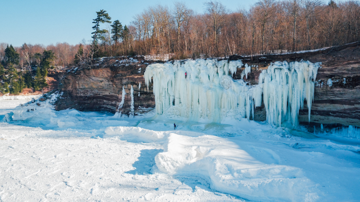 Ice climbers on icy cliffs at Grand Island.