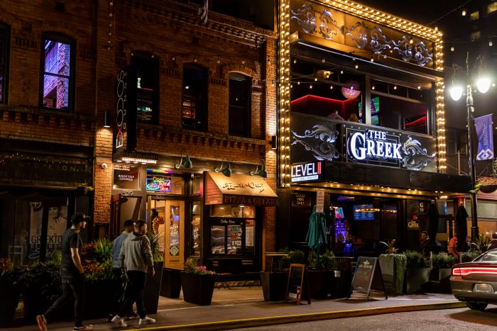 Local businesses at night in Greektown.