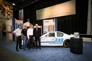 FROM LEFT: NASCAR drivers Sam Hornish Jr. and Ryan Newman, Michigan International Speedway's Roger Curtis, and Pure Michigan vice president George Zimmermann announce Pure Michigan will sponsor the track's August 400-mile NASCAR Sprint Cup Series race through 2014.
