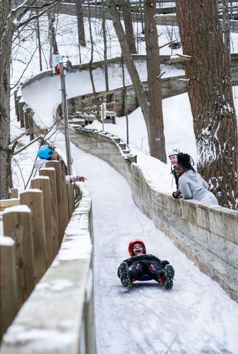 Child traveling down luge track.