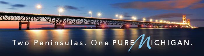 Mackinac Bridge Billboard that reads "Two Peninsulas, One Pure Michigan."