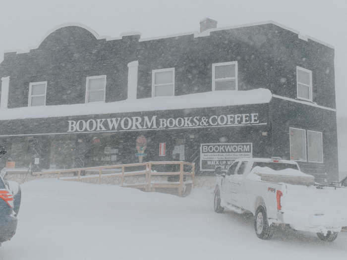 Snow falling outside Bookworm Books & Coffee.