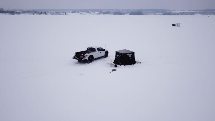 Ice shanty and pick up truck on frozen Little Bay de Noc