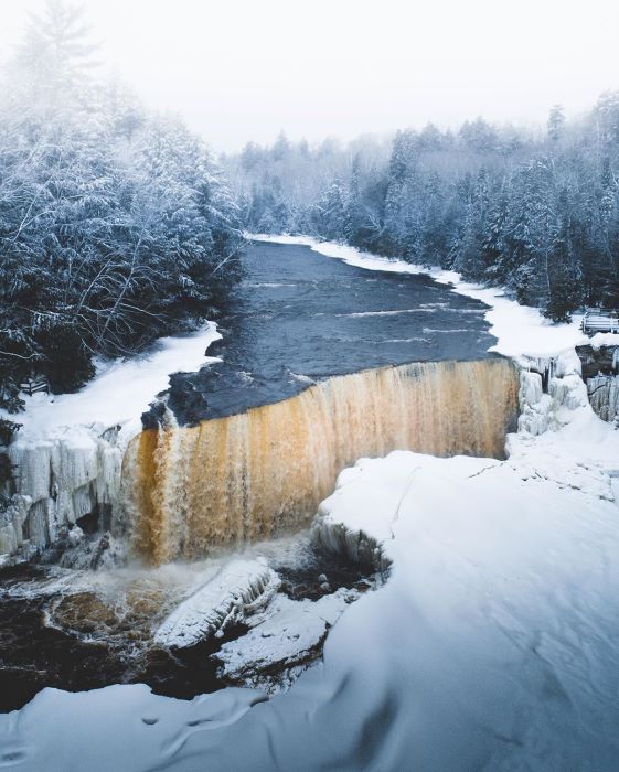 Tahquamenon Falls surrounded by ice during winter. 