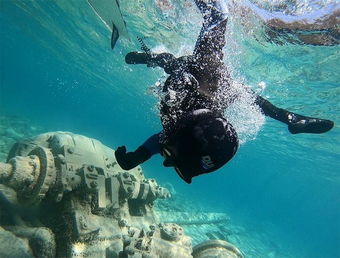 Diver examining shipwreck under water