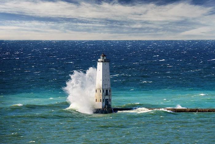 Lake Michigan waves crash against Frankfort North Pier Head Light