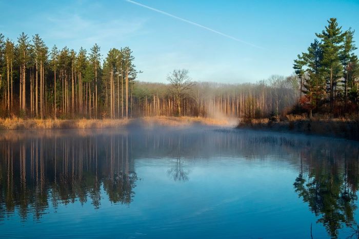 Morning mist over a lake along the Riley Trails in Holland