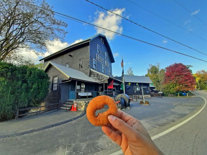 Aaron Cruz holding doughnut at Parshallville Cider Mill.