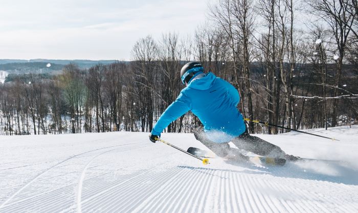 Downhill skier on fresh-groomed snow