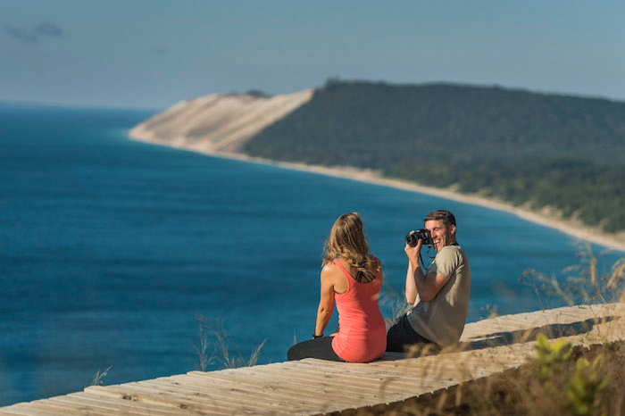 People sitting on boardwalk above Sleeping Bear Dunes National Lakeshore
