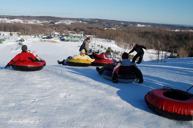 People at top of snow tube hill