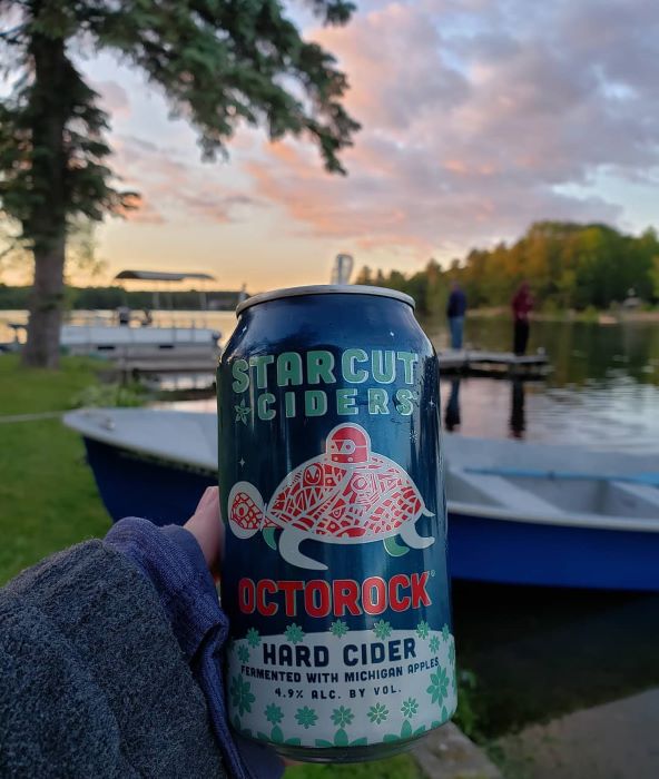 A can of Starcut Cider by the lake